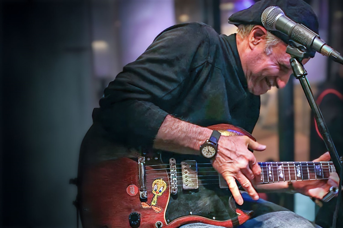 Musician Robert Ross playing guitar