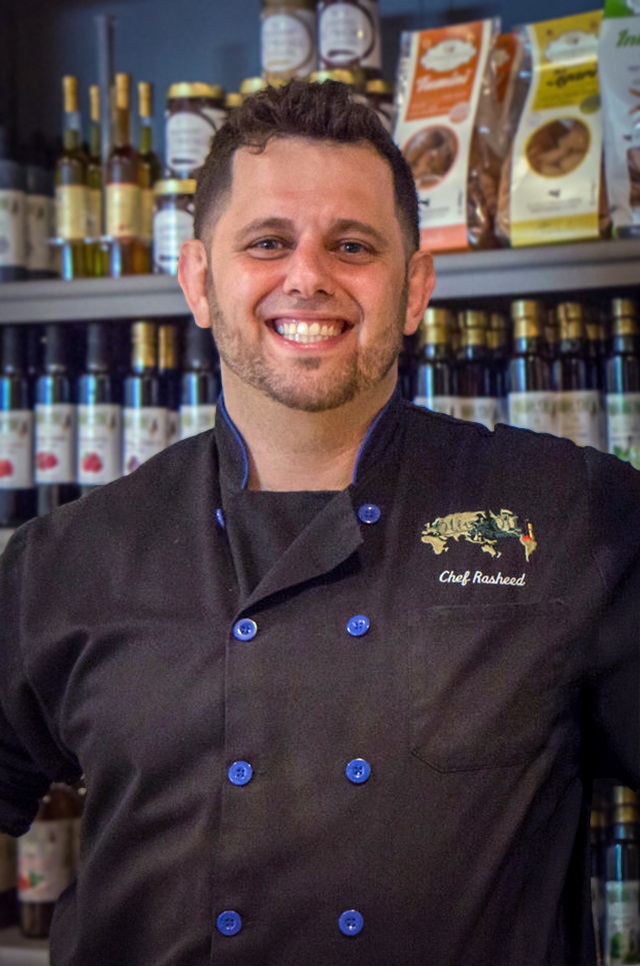 Portrait of Chef Rasheed in front of his olive oils