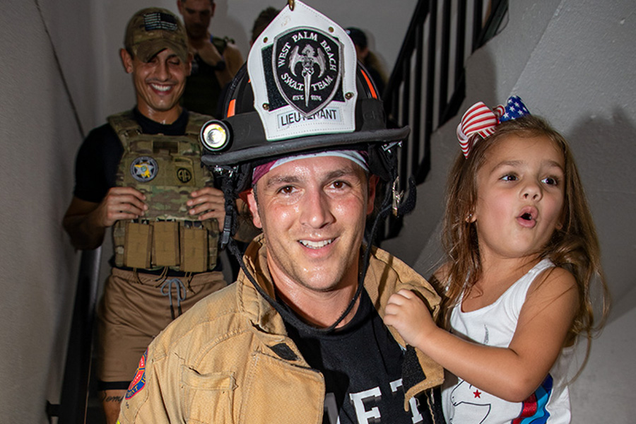 SM-Lt.-Scott-Langill-carries-his-daughter-a.jpg