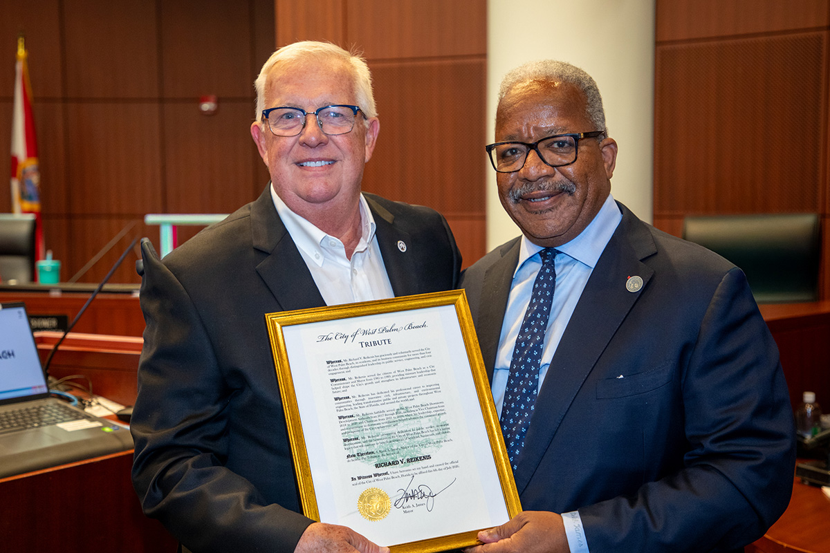 Two men standing, former Mayor Richard Reikenis, left, with Mayor Keith A. James, right