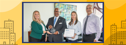 four people in photo for Better Buildings Challenge Award presentation