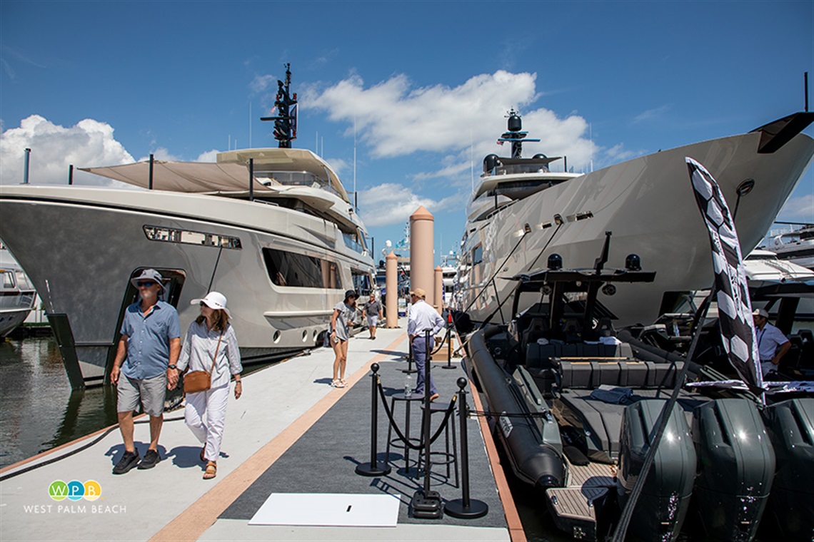 Palm Beach International Boat Show, people walking between yachts.