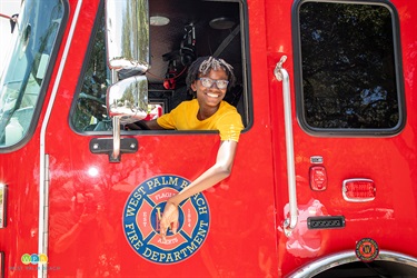 Junior Alert Graduate Jhaiden Williams tries out the driver's seat in a West Palm Beach Fire Truck