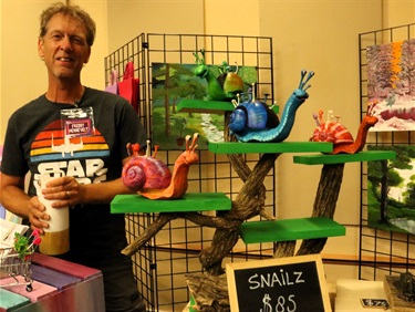 Artist with snail sculptures