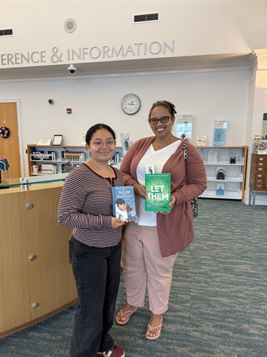 Two women holding books