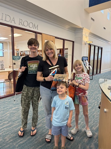 Family holding books