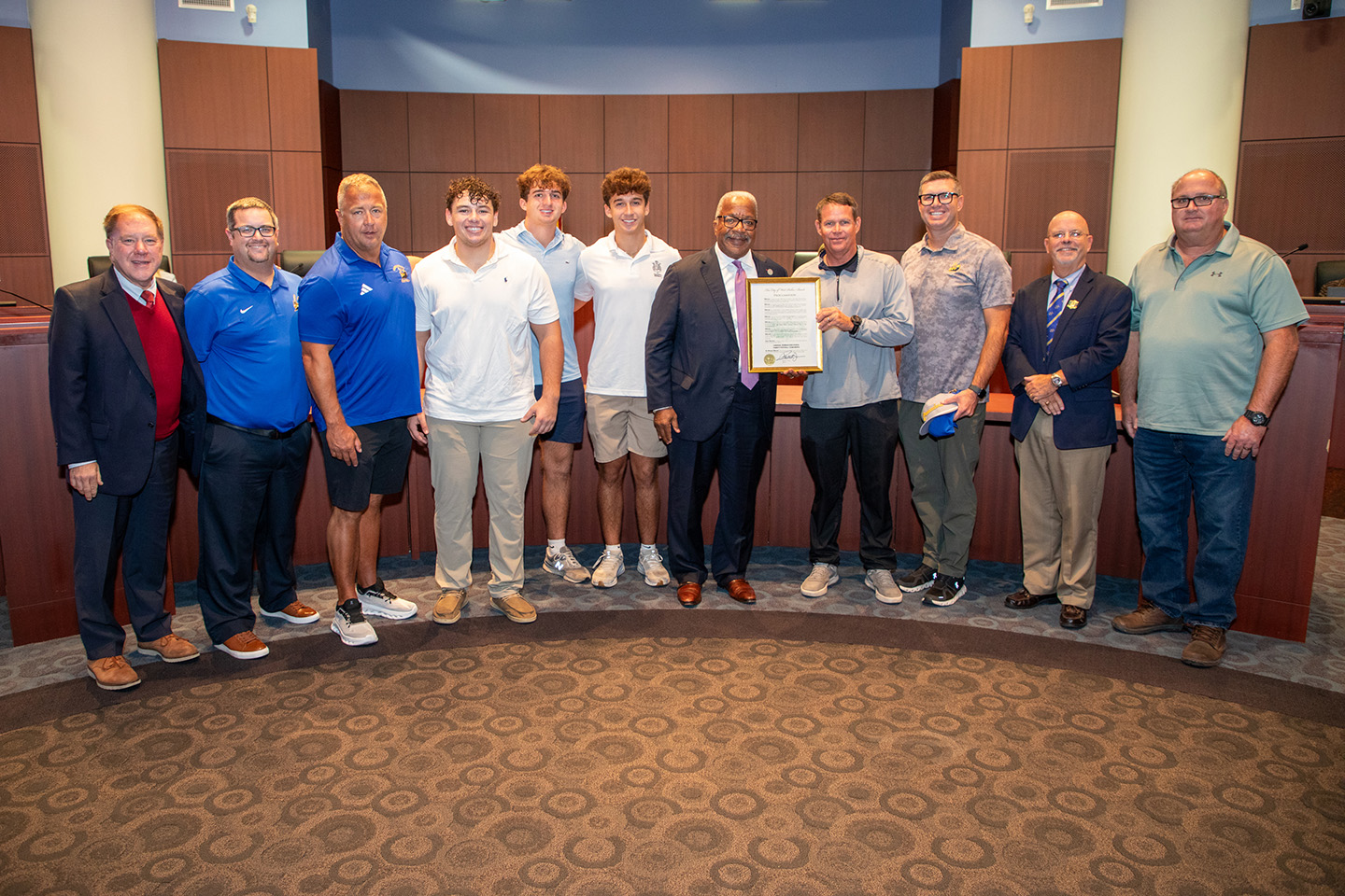 Members of the Cardinal Newman High School 2025 State Championship football team were presented with a proclamation by Mayor Keith A. James designating February 2026 as Cardinal Newman High School Varsity Football Month. 
