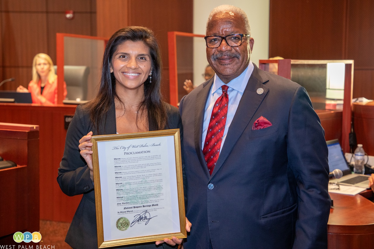 Kelsey Burke accepts proclamation from Mayor Keith A. James