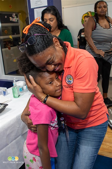 Youngster gets a hug at dinner time