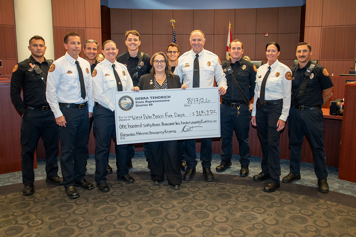 FD and City Accept check from State Rep. Debra Tendrich for Hazardous Waste and Chemical cleanup.11people standing holding large check