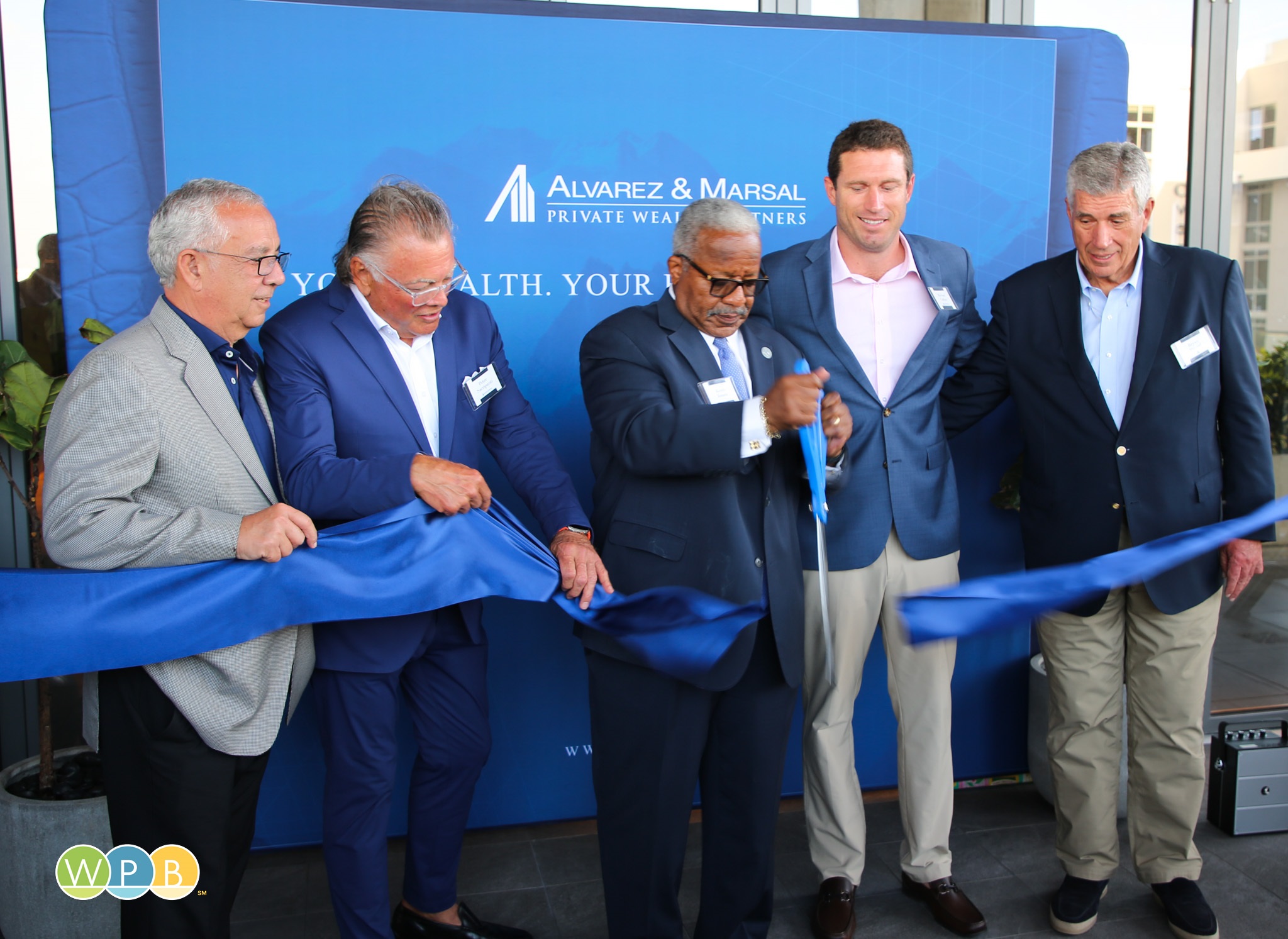 Cutting ribbon, from left, Tony Alvarez II, Peter Sacripanti, Mayor James, Michael Calkin, Bryan Marsal