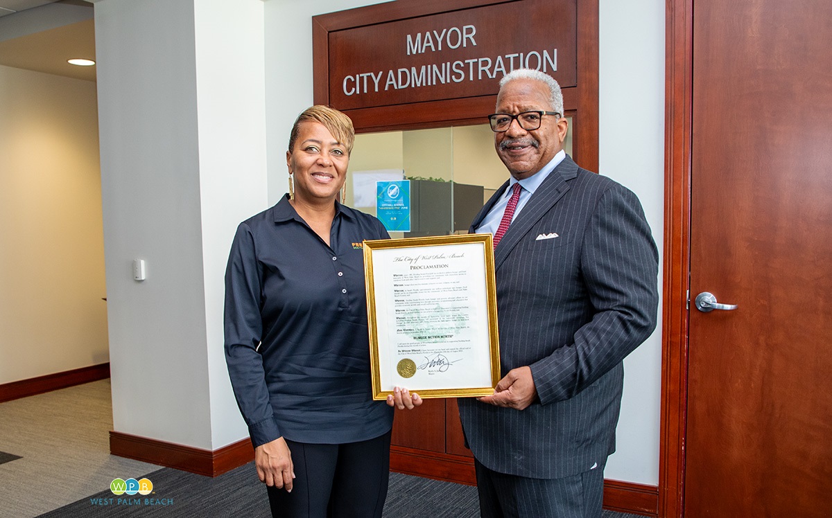 Allyson Vaulx accepts proclamation from Mayor Keith A. James