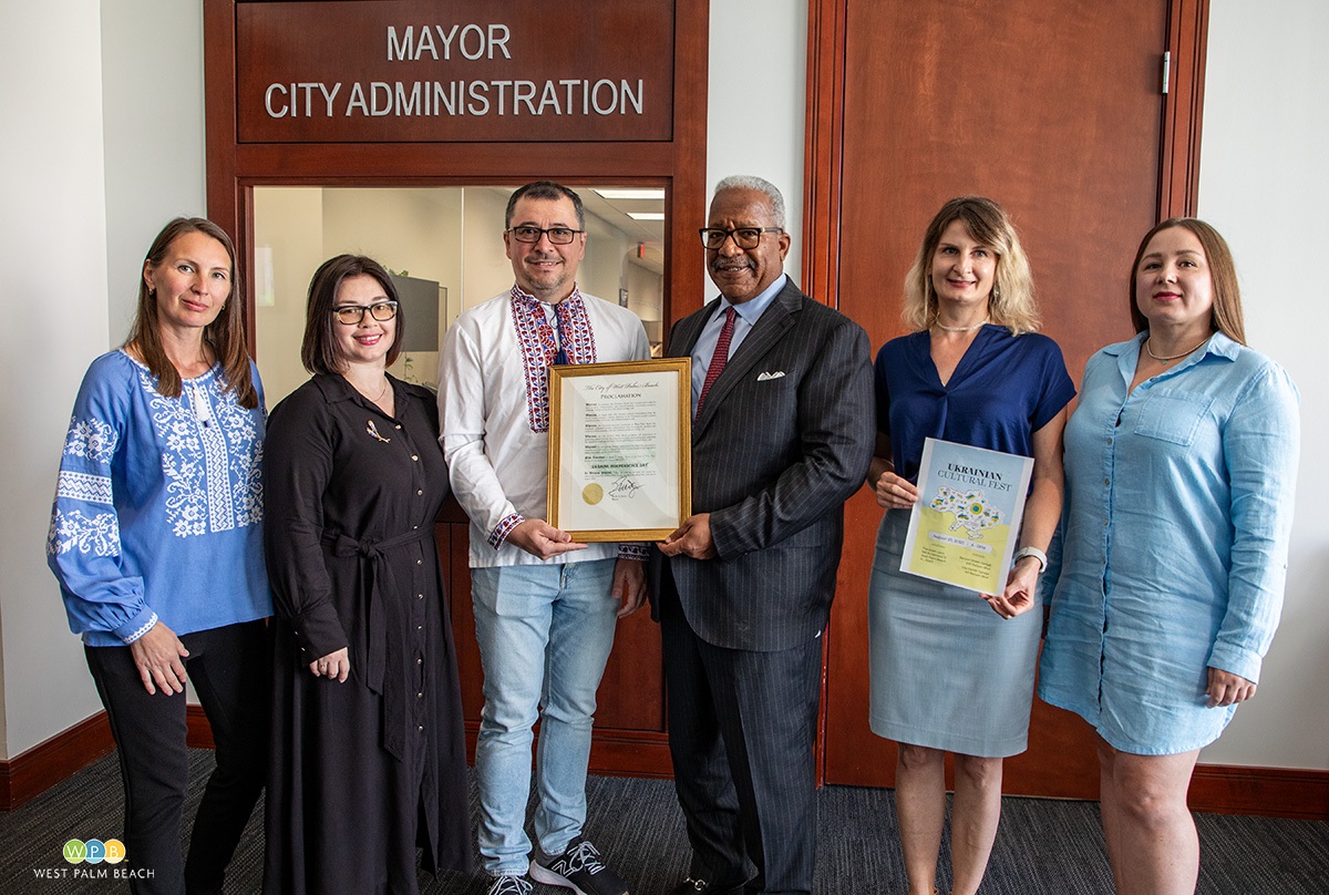 Six people standing, two women on each end with two men in the middle. Mayor presents proclamation.