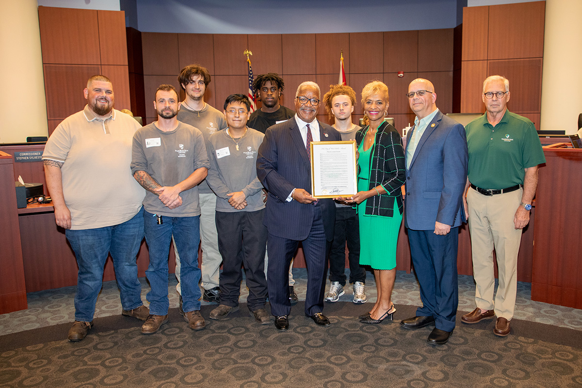 Dr. Ave Parker, Palm Beach State College President, accepts the proclamation from Mayor Keith A. James.