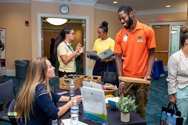 A man chats with a lady from the West Palm Beach Community Redevelopment Agency