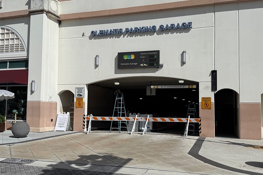 Tight photo of the gates blocking Clematis Street entrance to the Clematis Garage