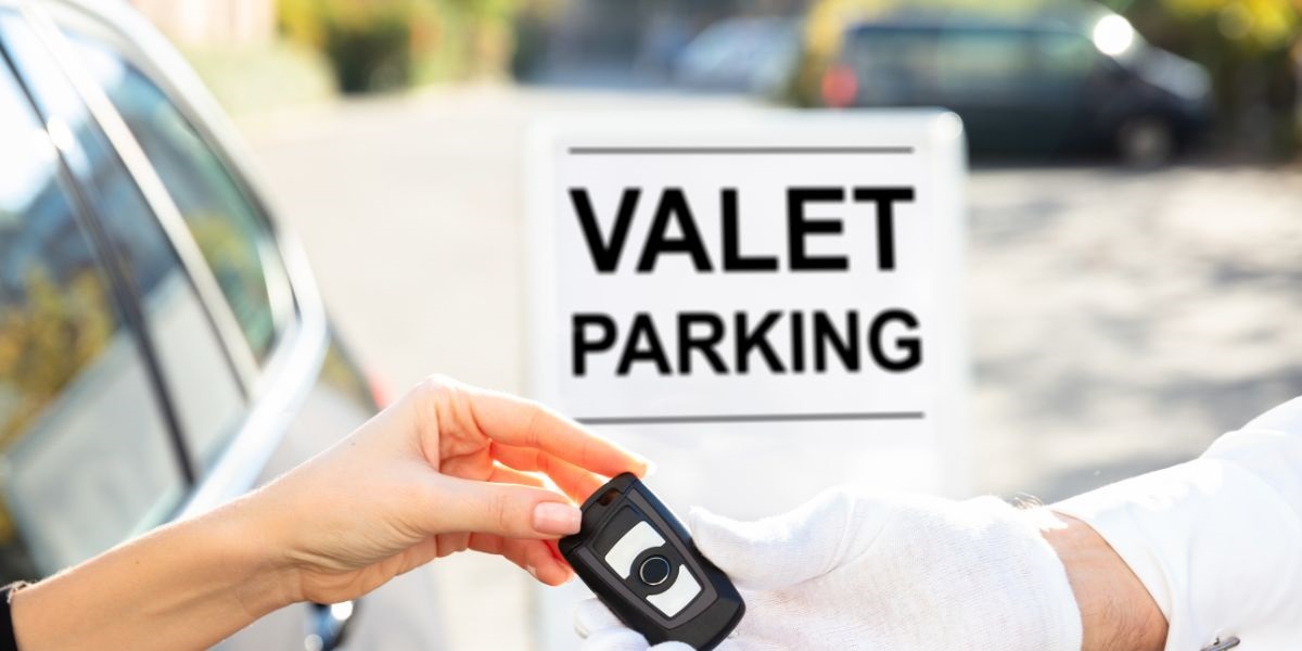 Stock photop of person handing keys to a Valet parking attendant