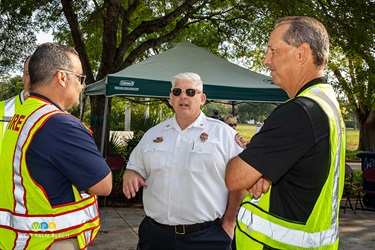 Assistant Chief Brent Bloomfield speaks with observers from the Coral Gables Fire Department